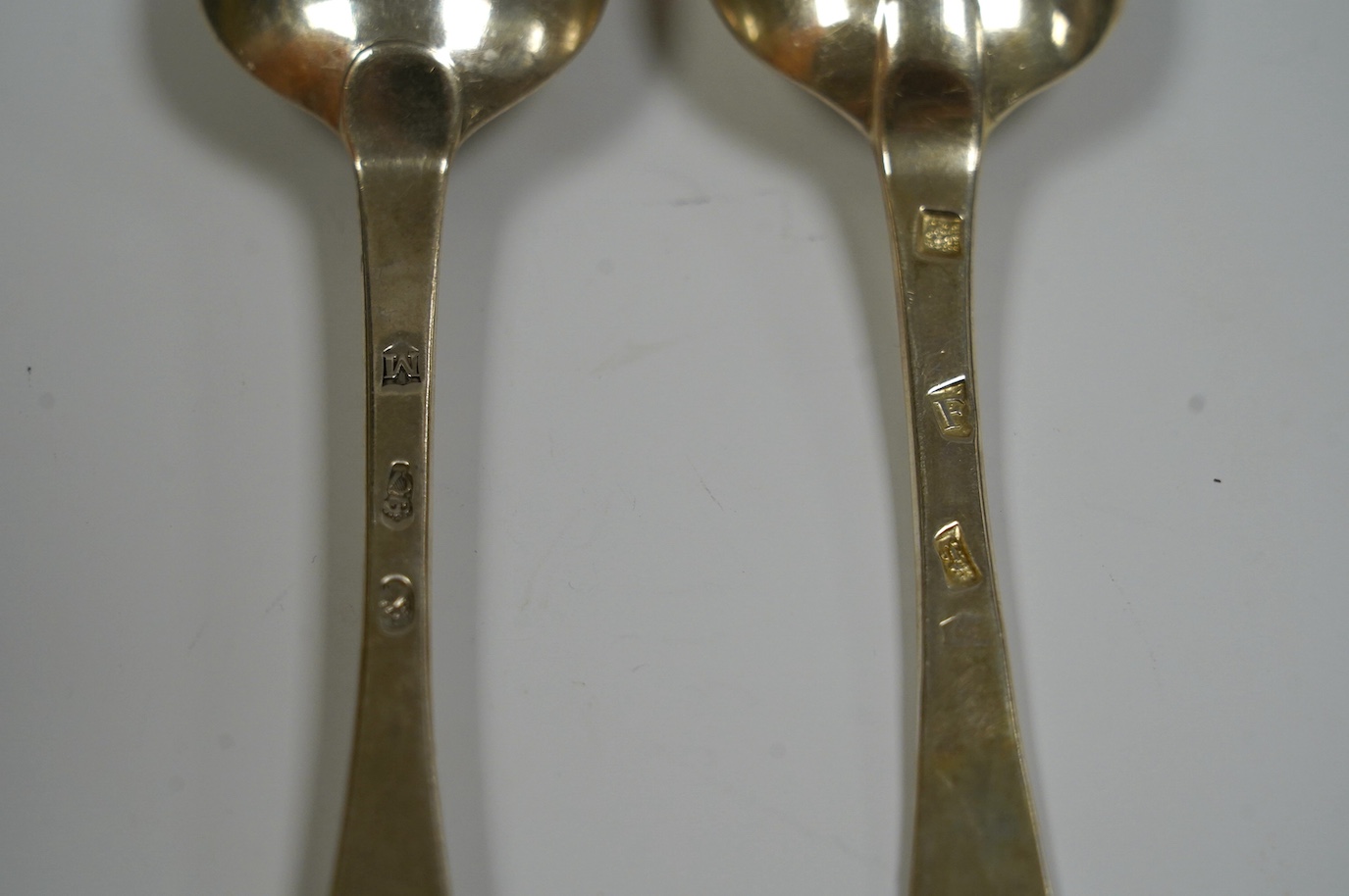 A George I silver Old English pattern table spoon, rubbed maker's mark, London, 1721 and a George III Irish silver table spoon, Dublin, 1760, 136 grams. Condition - fair